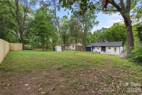 a view of a house with yard and a tree