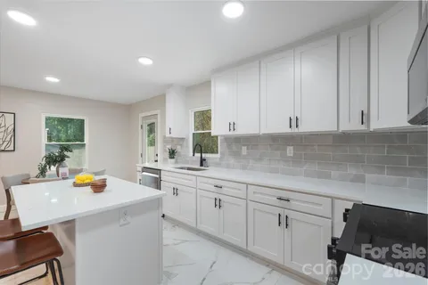 a kitchen with a sink a stove and cabinets