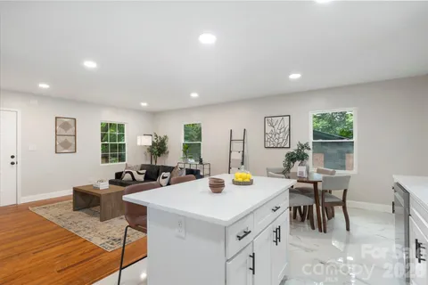 a view of a dining room with furniture and a potted plant
