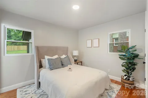 a bedroom with a bed and a potted plant