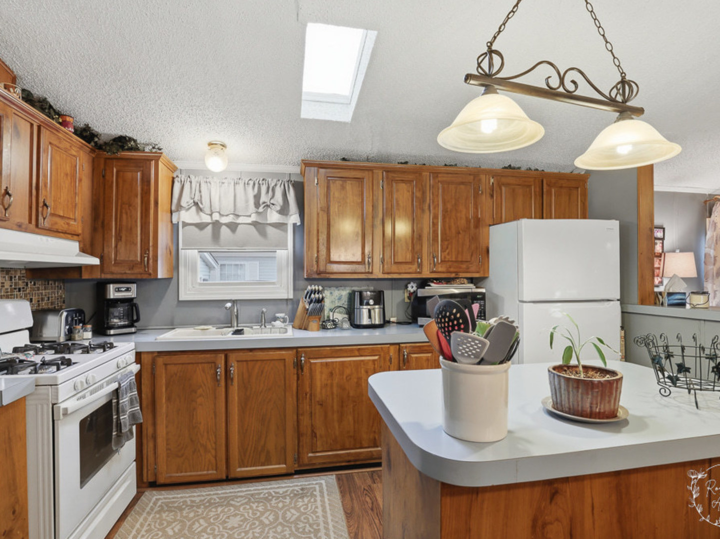 52 Partridge Lane Beecher, IL 60401 - Photo 10 of 24 a kitchen with stainless steel appliances granite countertop a sink a stove and a wooden cabinets