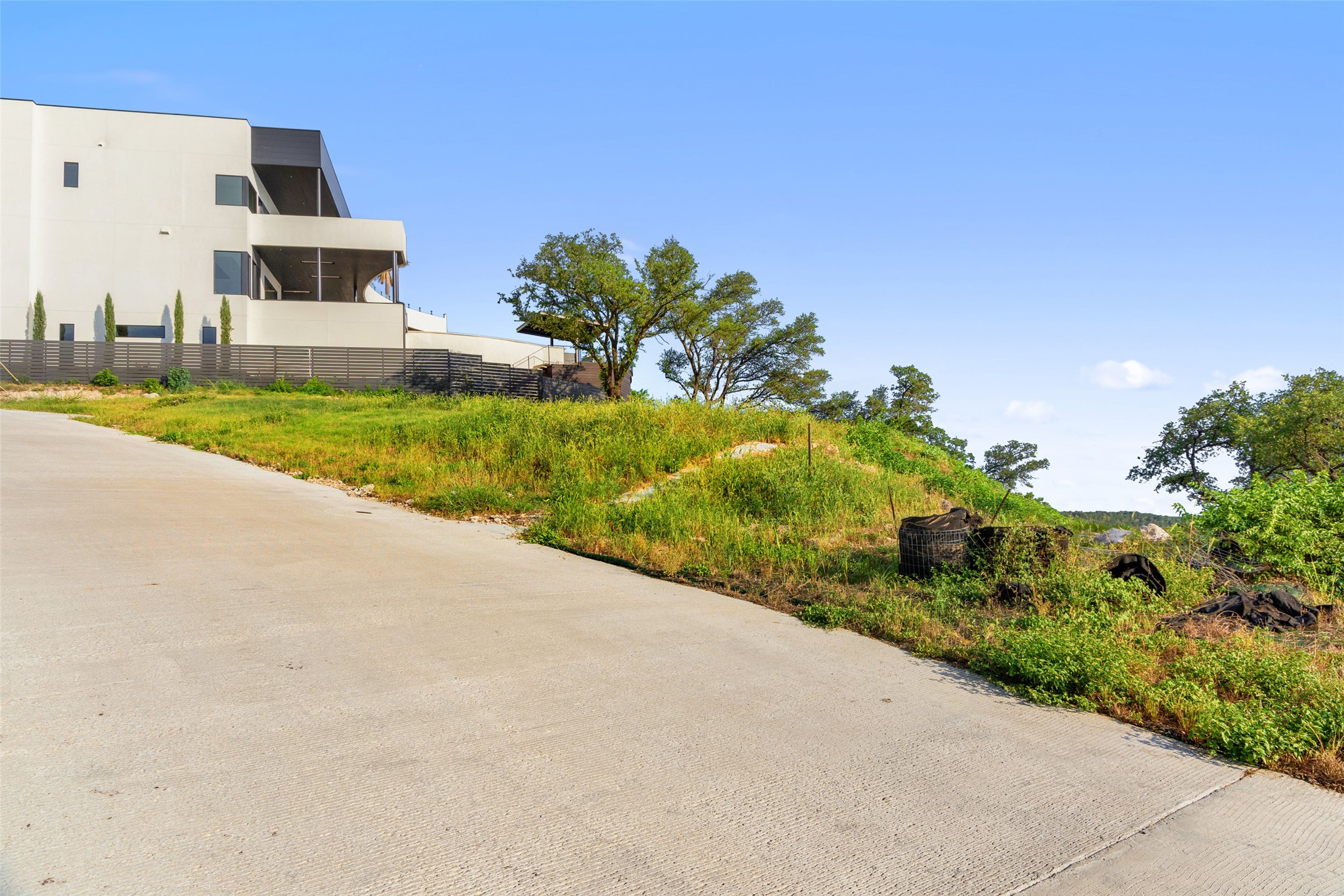 6813 Oasis Pass Austin, TX 78732 - Photo 25 of 36 a view of a house with a yard and potted plants