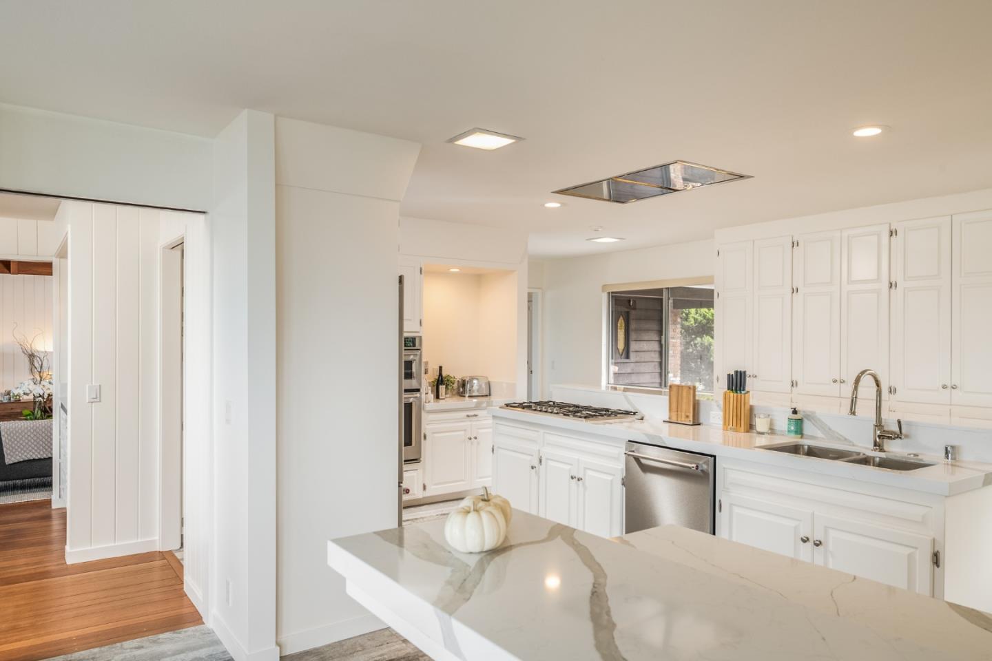 2715 Ribera Road Carmel, CA 93923 - Photo 21 of 41 a kitchen with a sink stove and cabinets