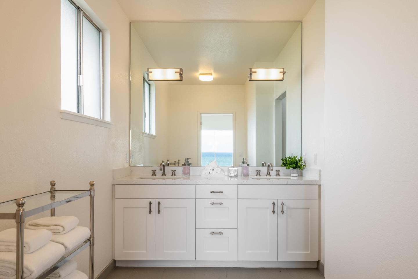 2715 Ribera Road Carmel, CA 93923 - Photo 28 of 41 a bathroom with a double vanity sink and a mirror