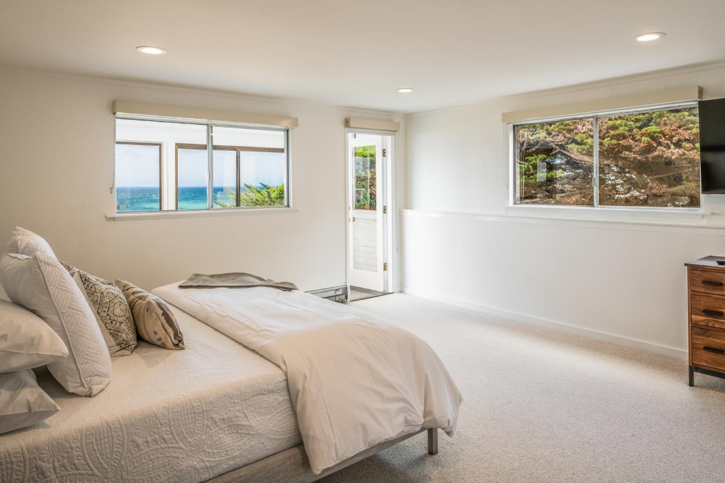 2715 Ribera Road Carmel, CA 93923 - Photo 29 of 41 a bedroom with a bed and a large window
