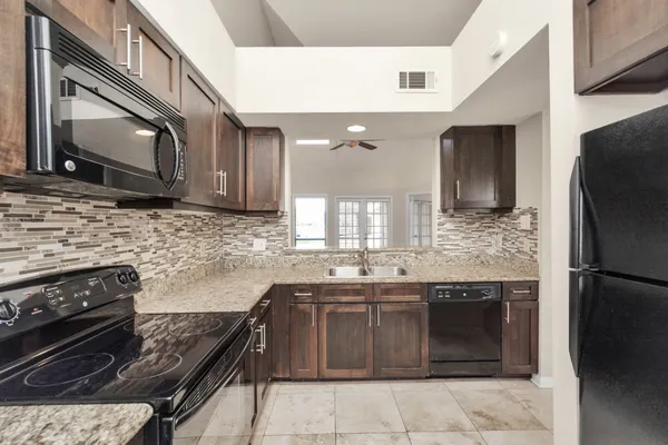 a kitchen with a sink stove and refrigerator