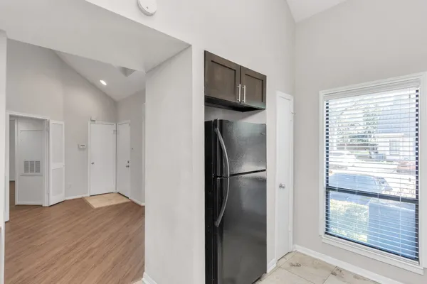 a view of empty room with wooden floor and window