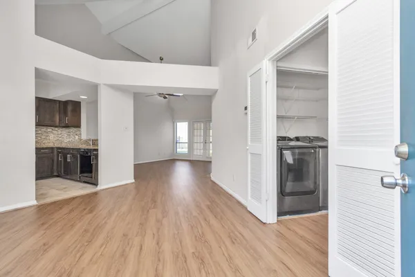 a view of a kitchen cabinets and wooden floor
