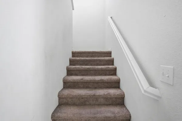 a view of staircase with white walls