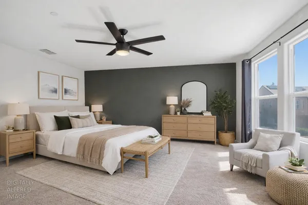 a bedroom with a bed couch and window