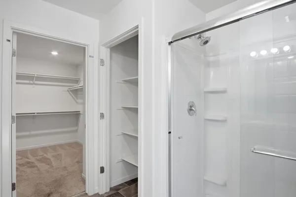 a bathroom with a shower and a glass door