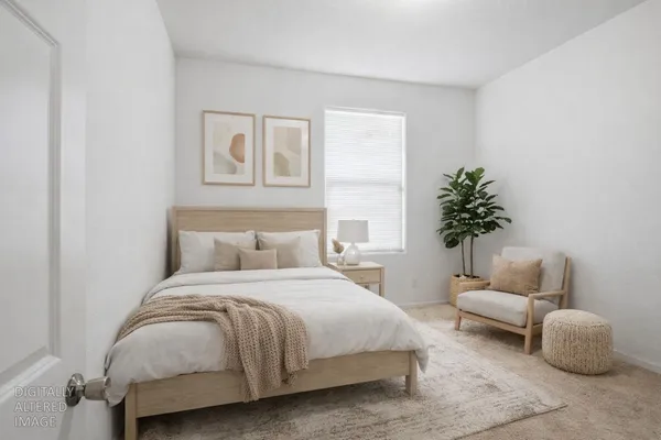 a bedroom with a bed and a couch