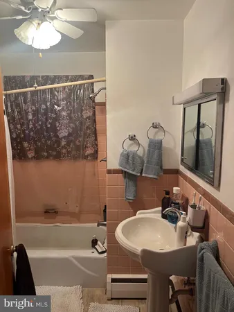 a bath room with a sink and a mirror
