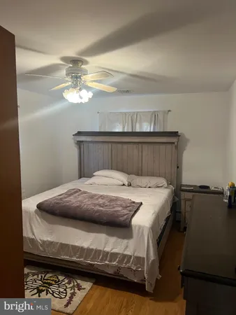 a bed sitting in a bedroom next to a cabinet
