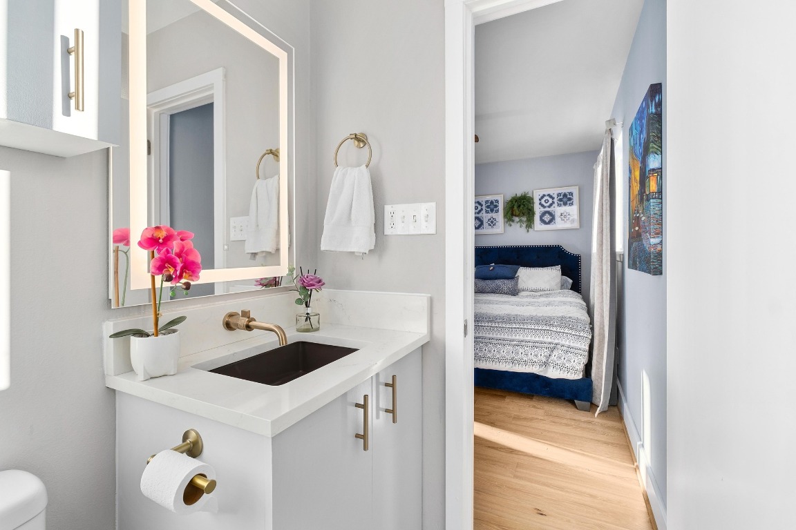 5307 Halmark Drive Austin, TX 78723 - Photo 18 of 31 a en suite bathroom with a sink and a mirror