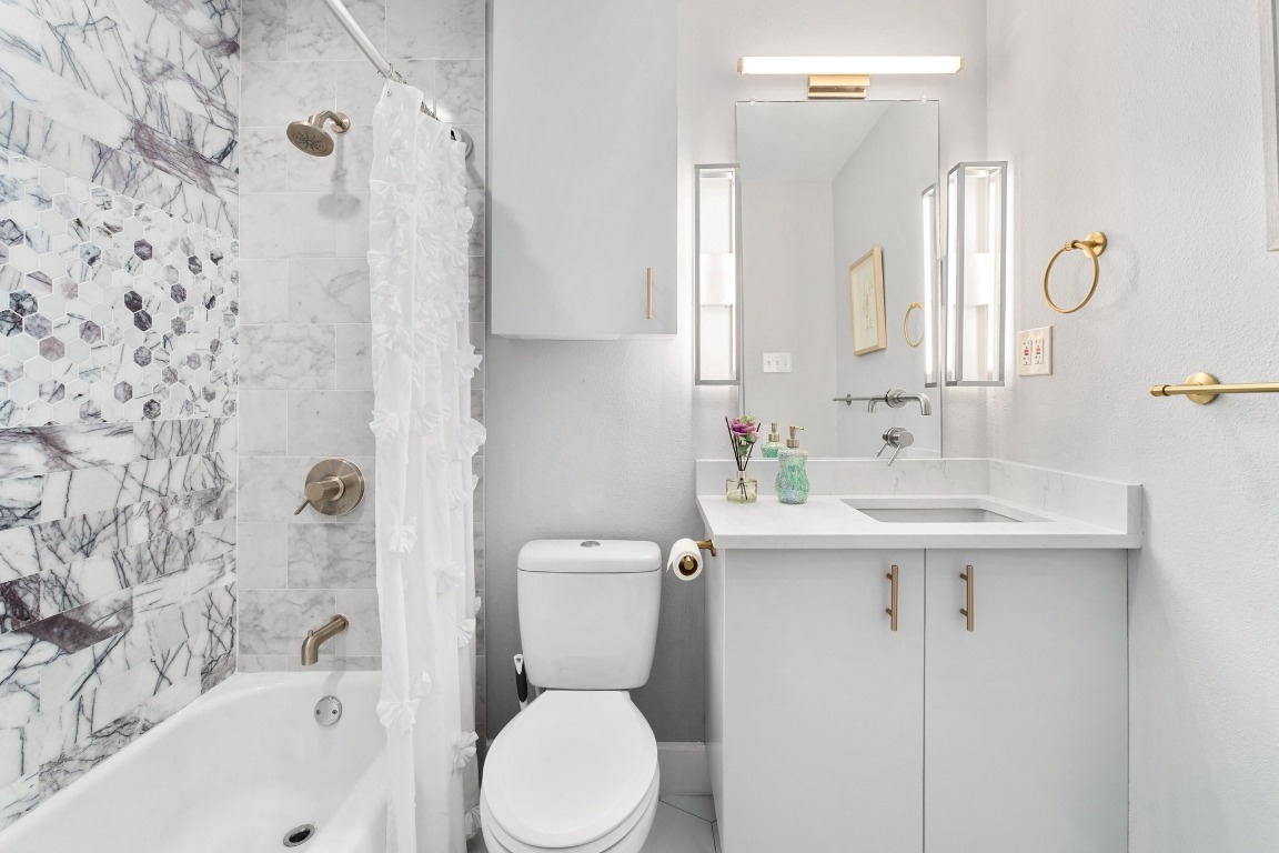 5307 Halmark Drive Austin, TX 78723 - Photo 21 of 31 a bathroom with a sink toilet and shower