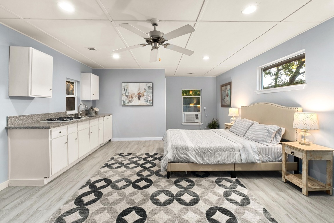 5307 Halmark Drive Austin, TX 78723 - Photo 24 of 31 a bedroom with a bed and a chandelier