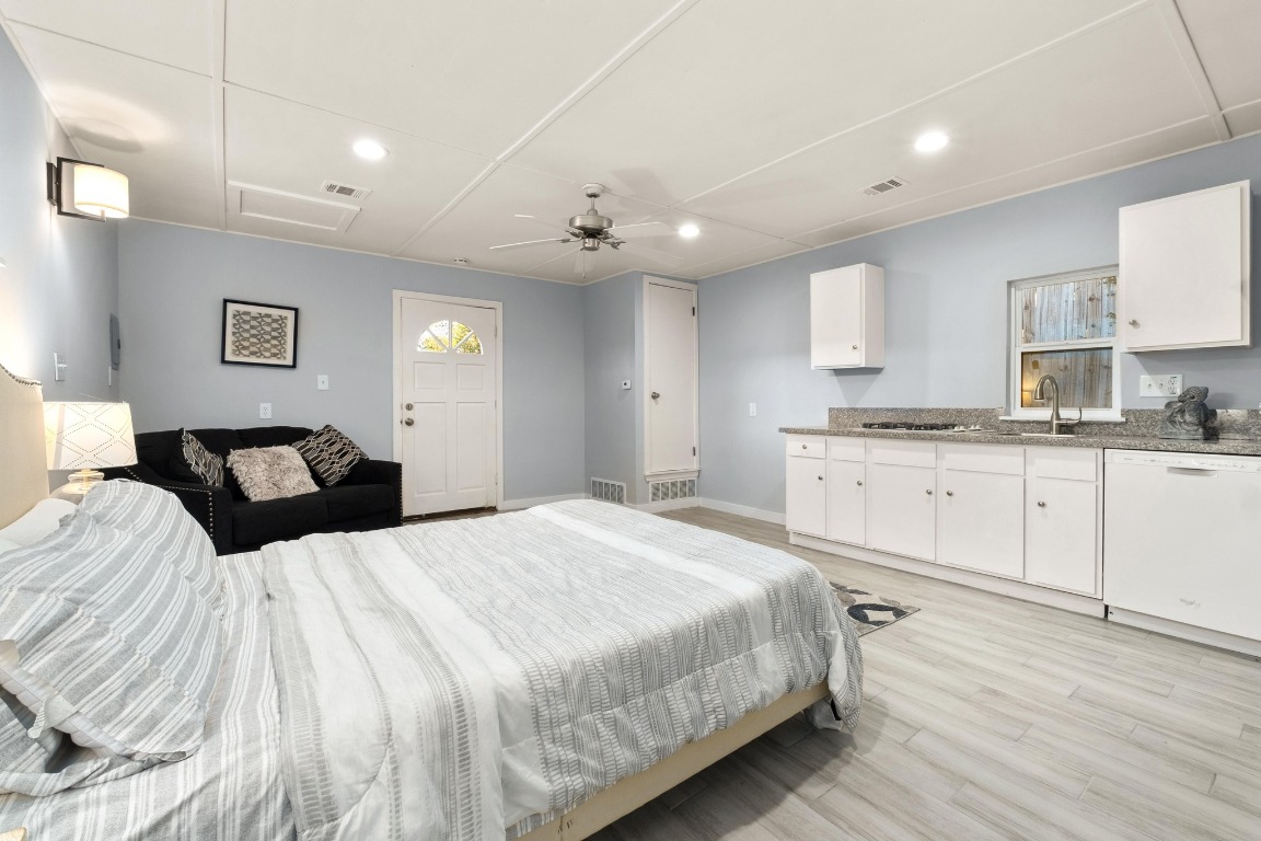 5307 Halmark Drive Austin, TX 78723 - Photo 25 of 31 a spacious bedroom with a bed and a cabinets