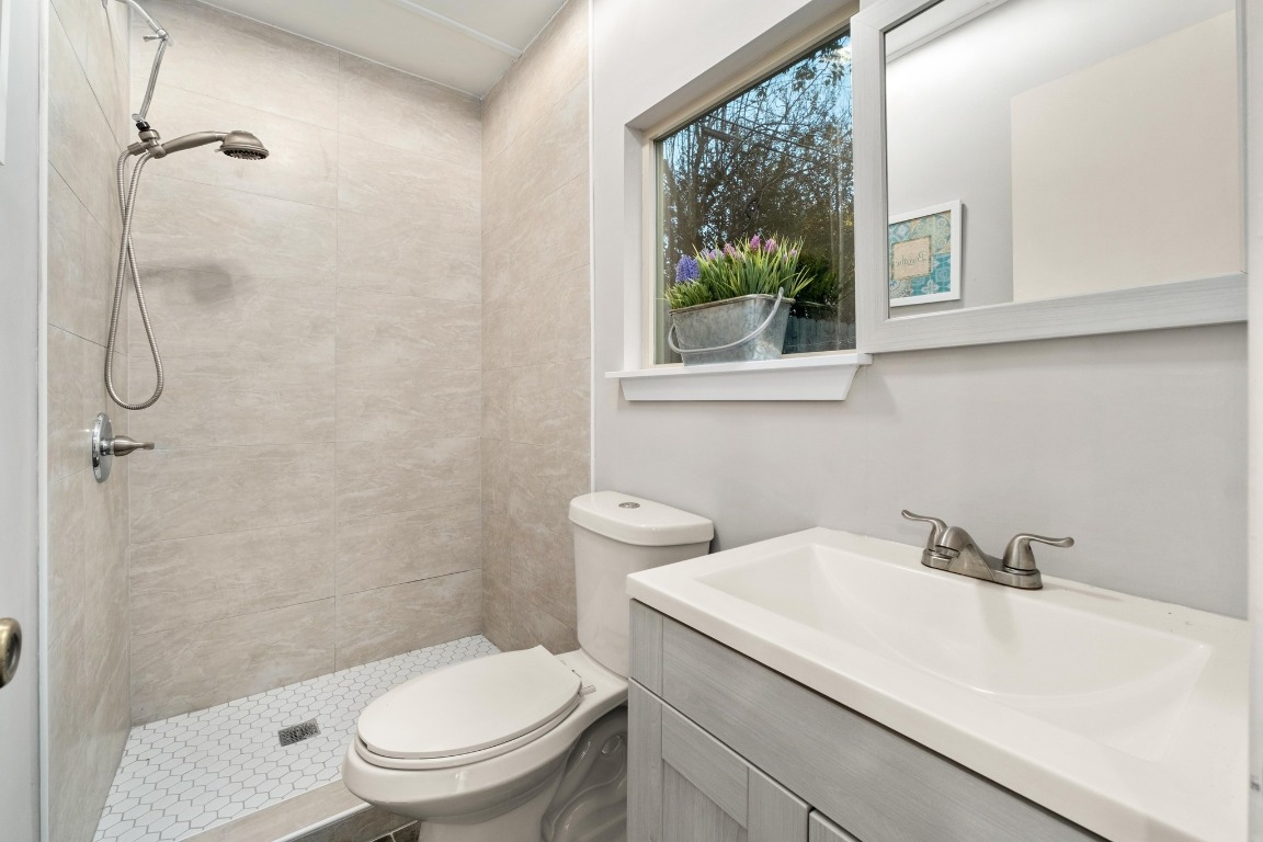 5307 Halmark Drive Austin, TX 78723 - Photo 27 of 31 a bathroom with a sink a toilet and a shower