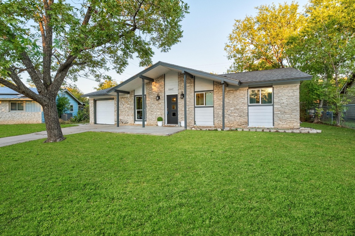 5307 Halmark Drive Austin, TX 78723 - Photo 31 of 31 a front view of house with yard and green space