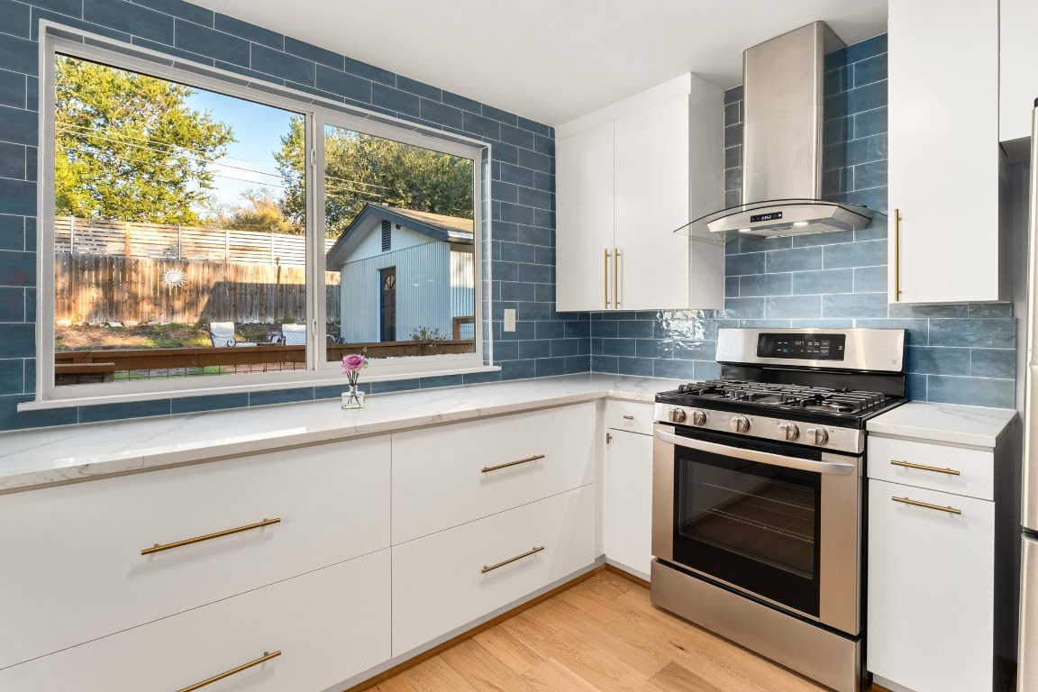 5307 Halmark Drive Austin, TX 78723 - Photo 9 of 31 a kitchen with granite countertop white cabinets and a stove