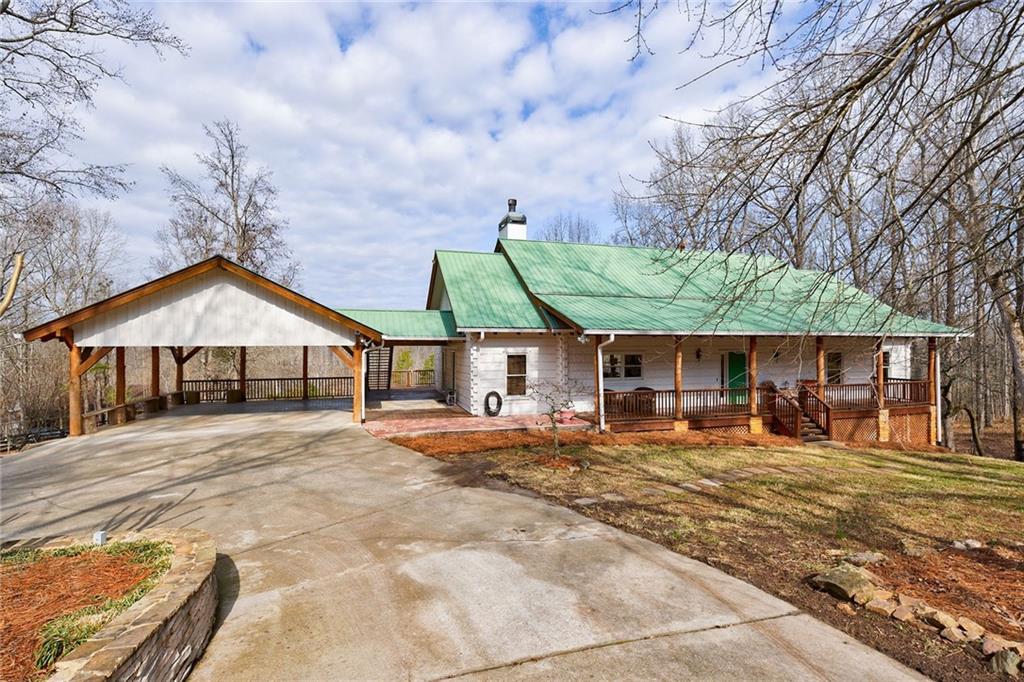 2865 Hightower Road Ball Ground, GA 30107 - Photo 1 of 1 a wooden bench sitting in front of a house