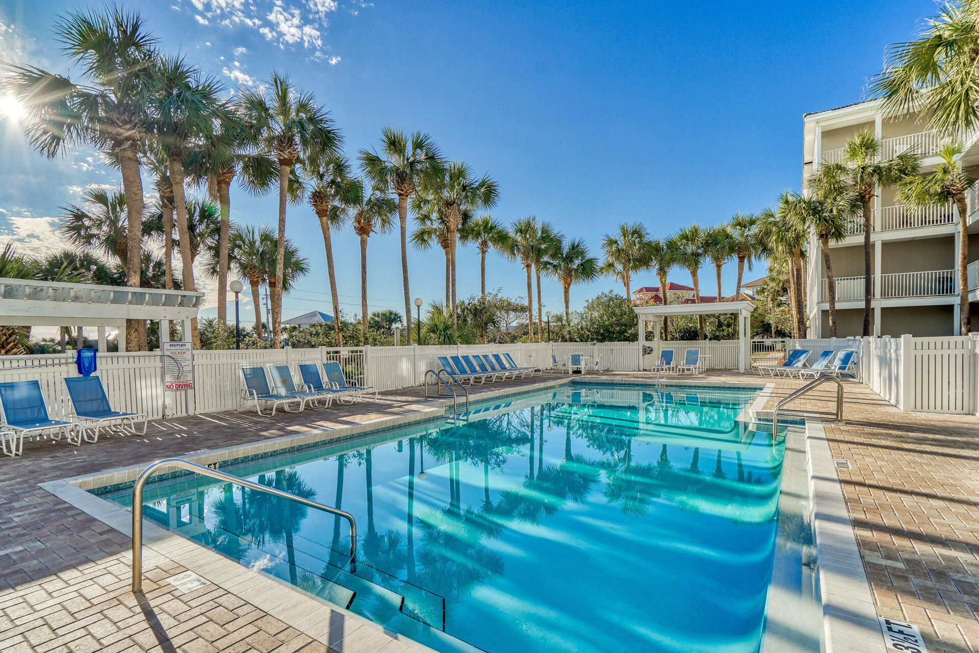393 South Co Highway 393, Unit 203 Santa Rosa Beach, FL 32459 - Photo 27 of 40 a view of a swimming pool with a patio and a yard