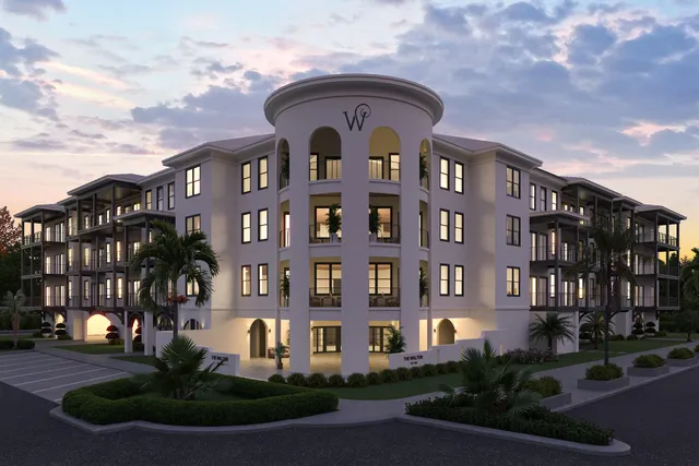 a front view of a residential apartment building with a yard