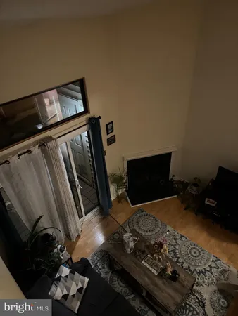 a living room with furniture gym equipment and a chandelier