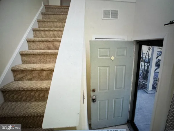a view of a room with wooden floor and white walls