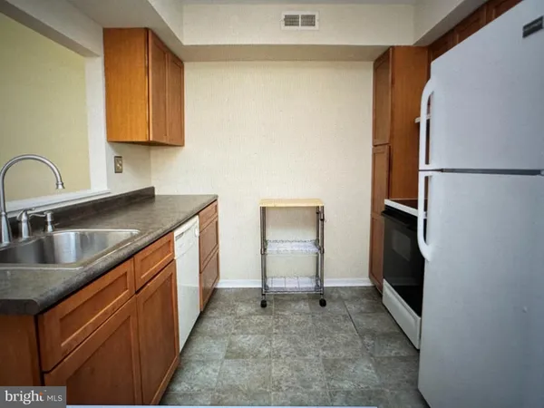 a kitchen with a refrigerator and a stove