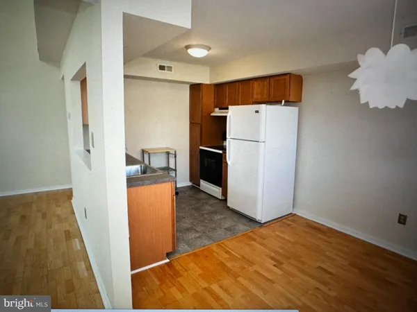 a view of empty room with wooden floor and fireplace