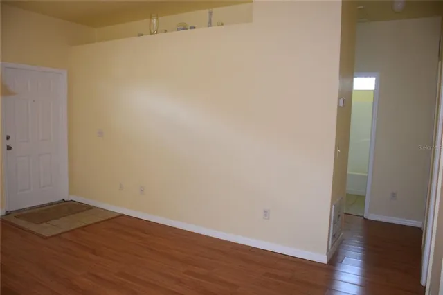 an empty room with wooden floor