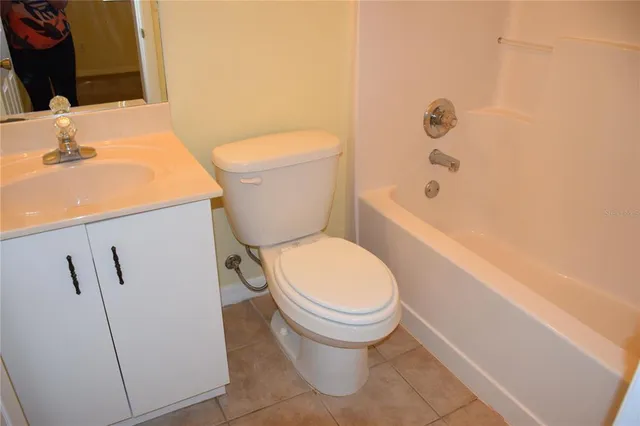 a white toilet sitting next to a bathroom sink