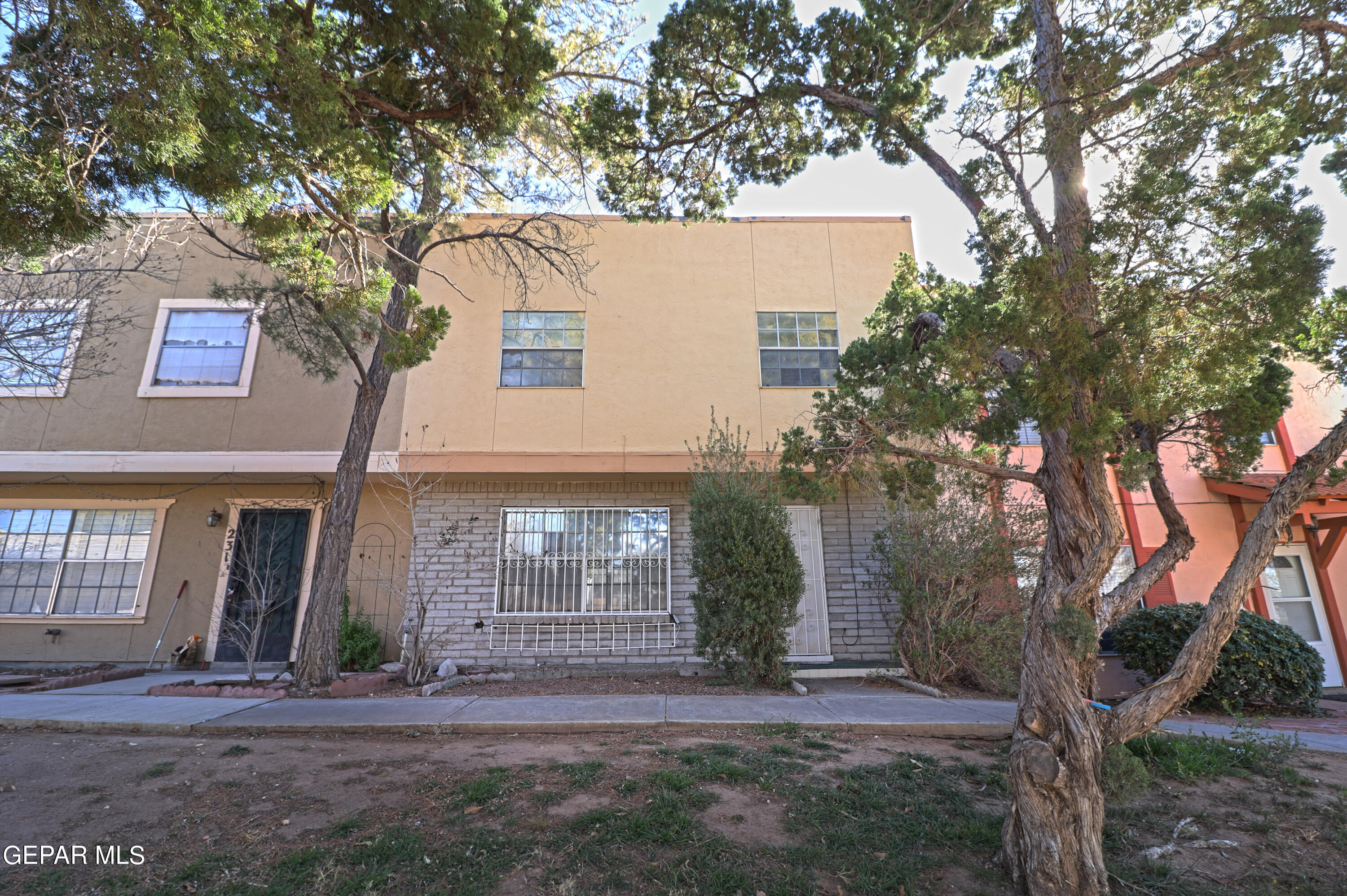 233 Maricopa Drive El Paso, TX 79912 - Photo 1 of 1 a view of a house with brick walls plants and large tree