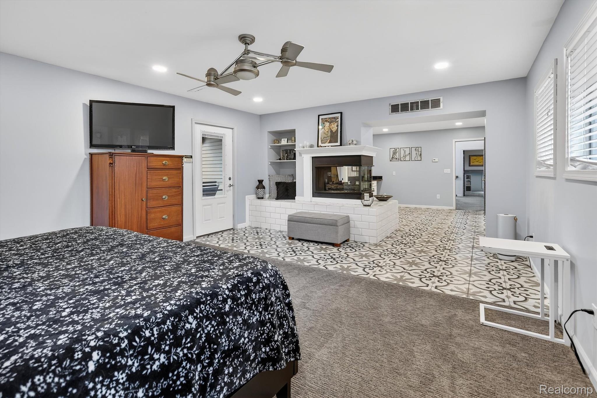 552 North McKinley Road Flushing, MI 48433 - Photo 26 of 98 Tiled bedroom featuring carpet floors, a ceiling fan, a brick fireplace, and recessed lighting
