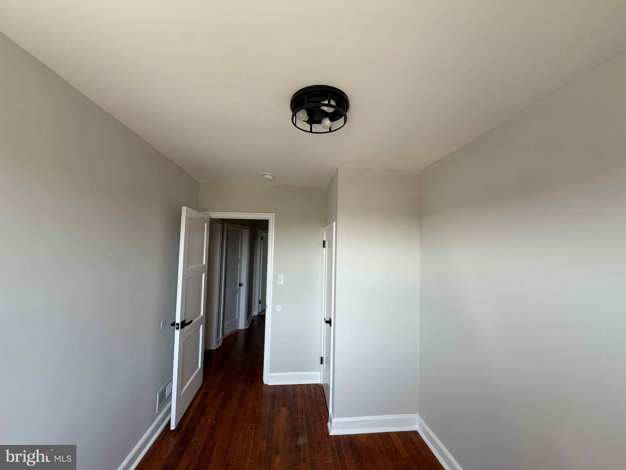 1535 East Cold Spring Lane Baltimore, MD 21218 - Photo 12 of 24 a view of a hallway with wooden floor