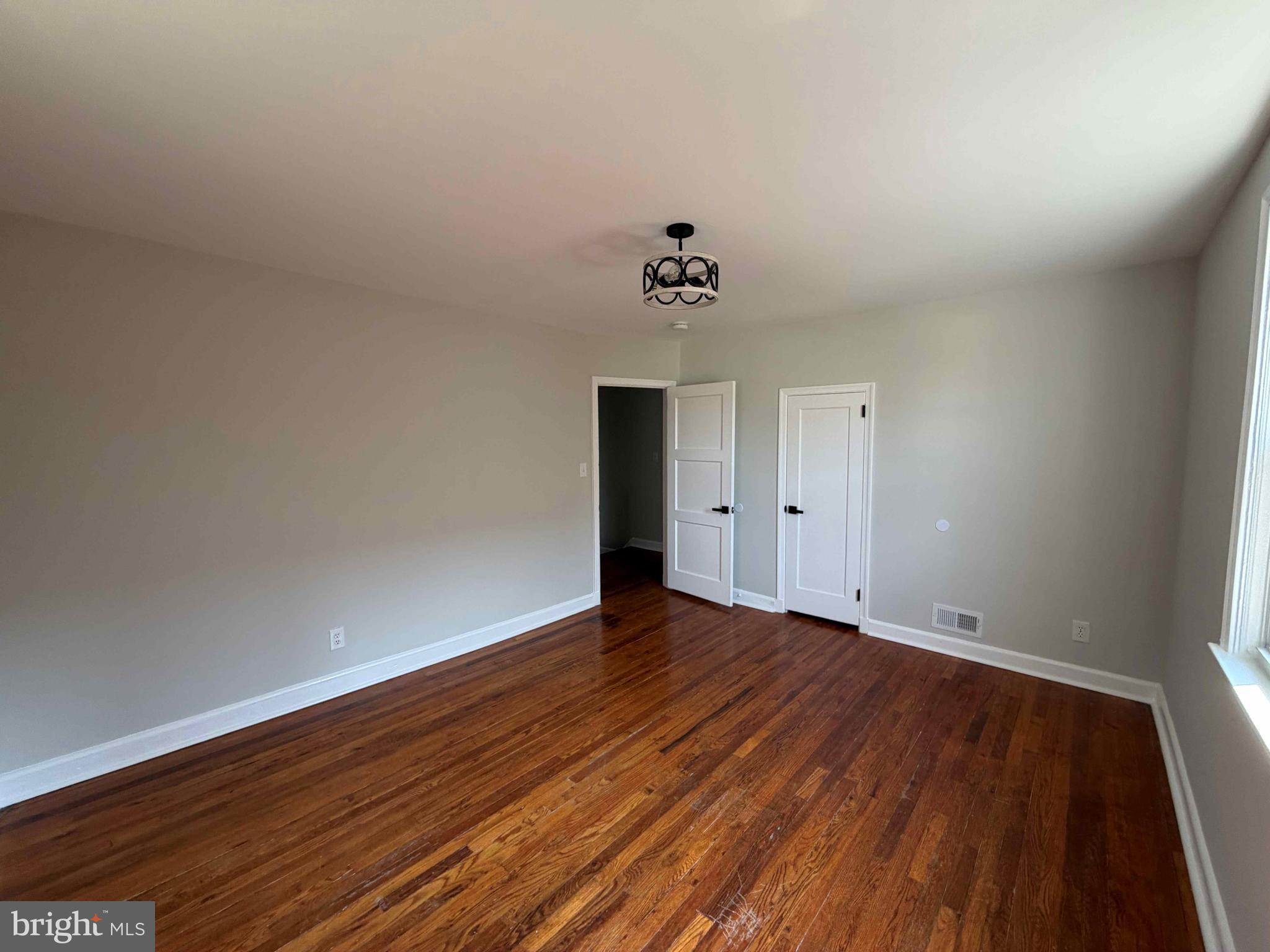 1535 East Cold Spring Lane Baltimore, MD 21218 - Photo 16 of 24 a view of an empty room with wooden floor
