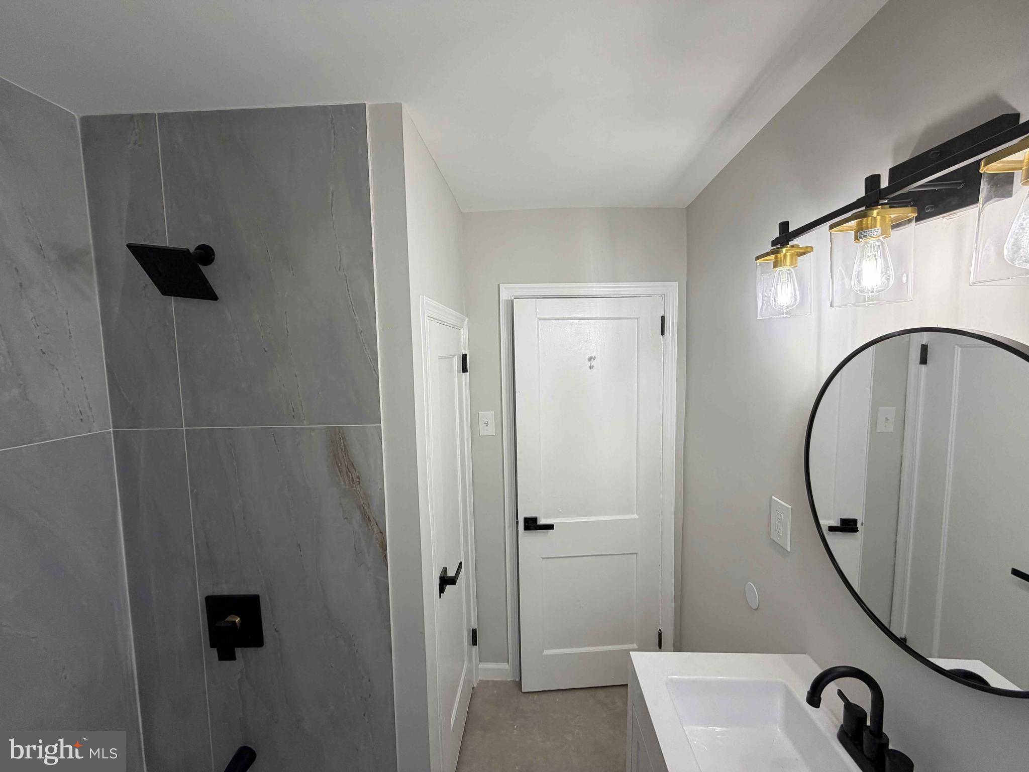 1535 East Cold Spring Lane Baltimore, MD 21218 - Photo 19 of 24 a bathroom with a sink and a mirror