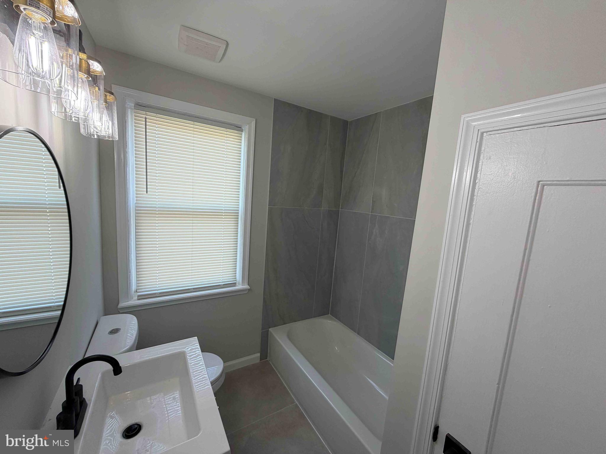 1535 East Cold Spring Lane Baltimore, MD 21218 - Photo 21 of 24 a bathroom with a sink a window and tub