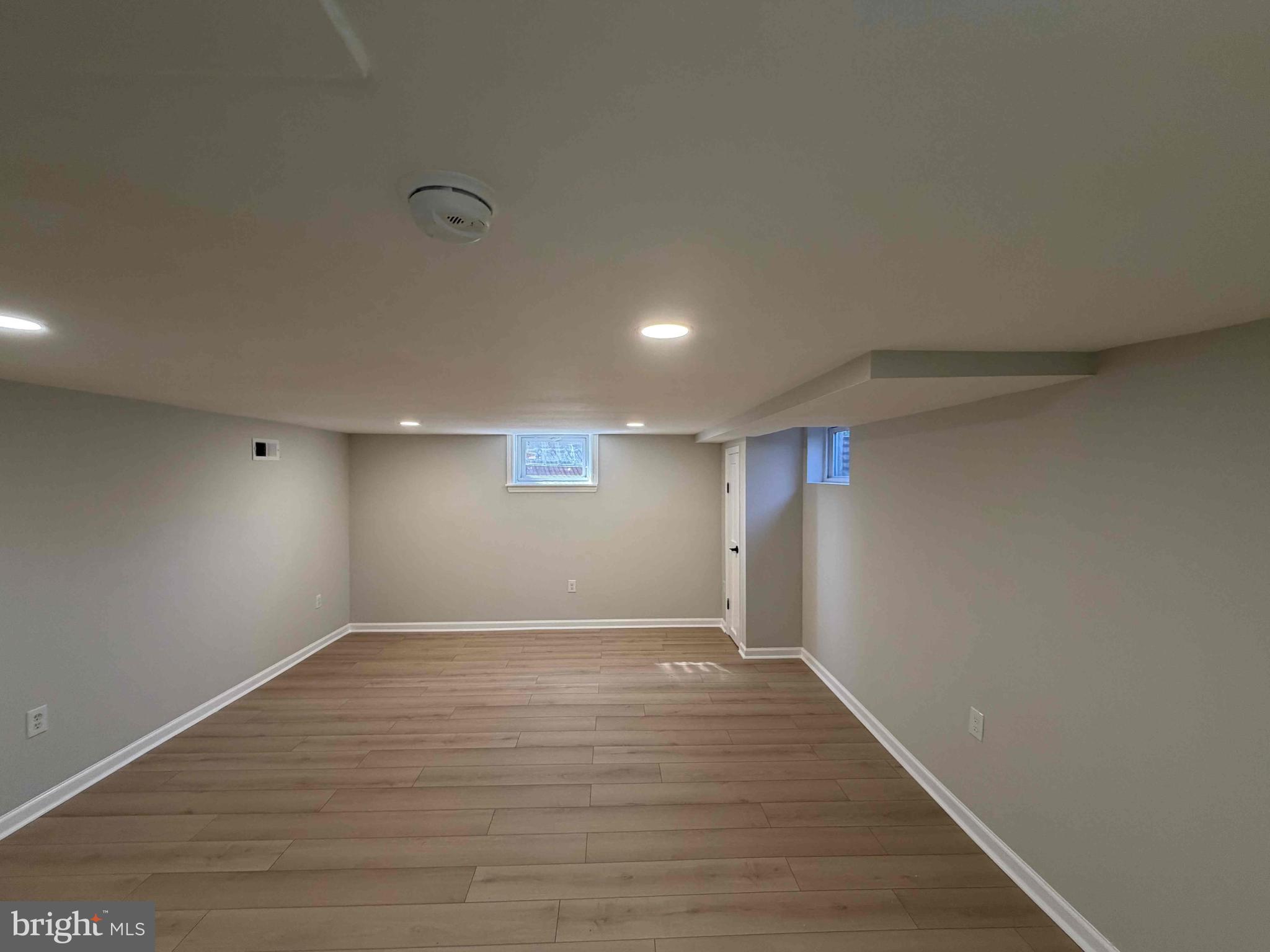1535 East Cold Spring Lane Baltimore, MD 21218 - Photo 22 of 24 a view of an empty room with wooden floor