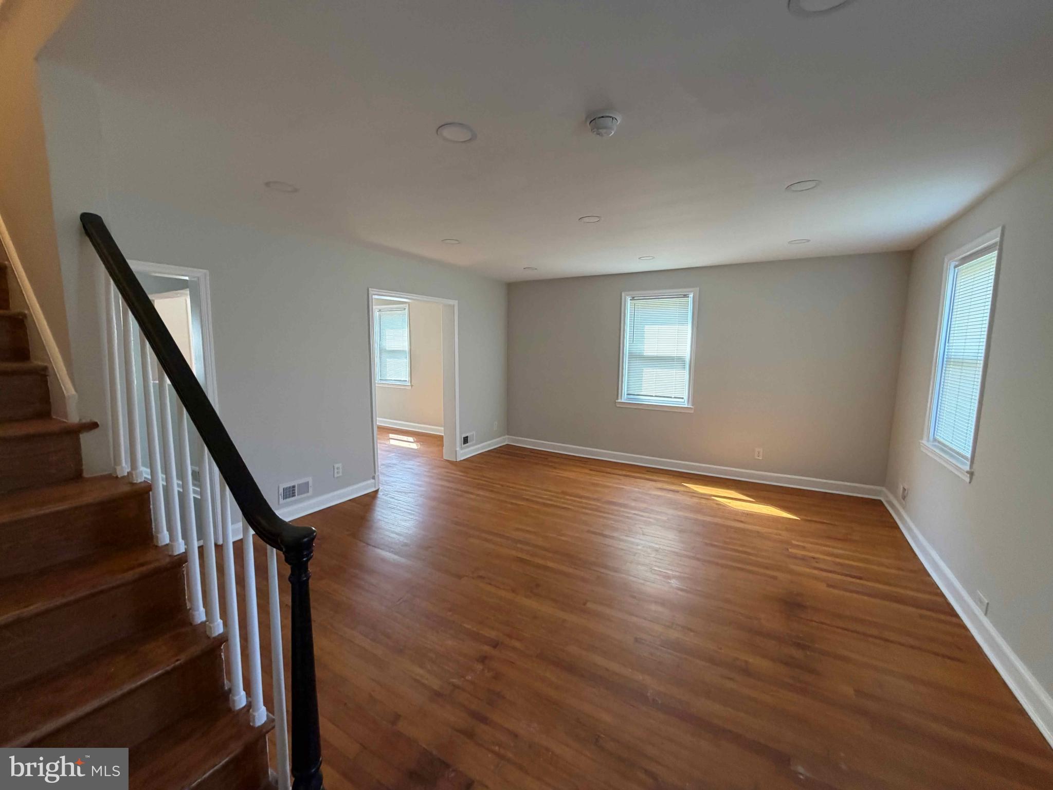 1535 East Cold Spring Lane Baltimore, MD 21218 - Photo 4 of 24 a view of an empty room with wooden floor and fan