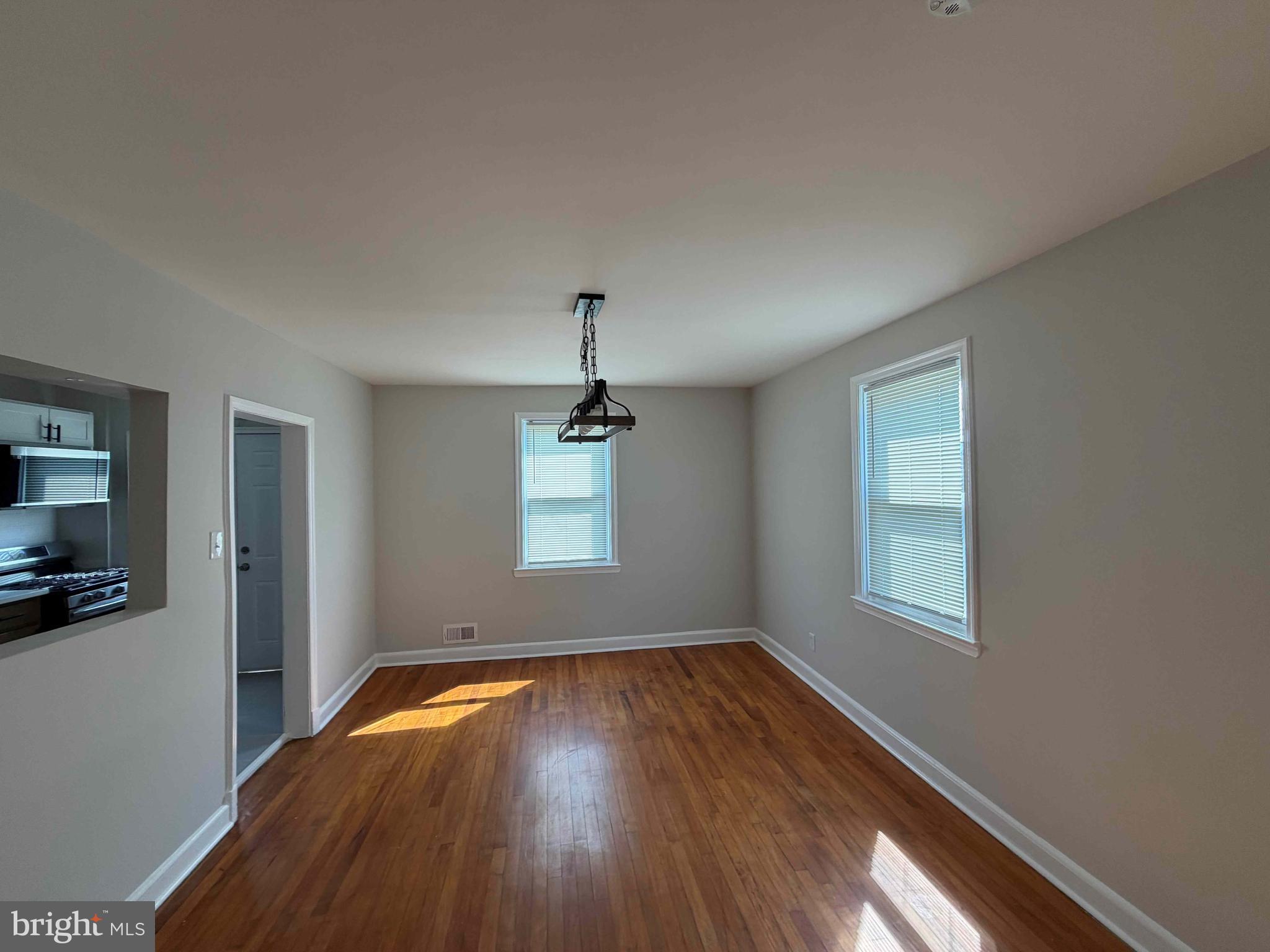 1535 East Cold Spring Lane Baltimore, MD 21218 - Photo 5 of 24 a view of empty room with wooden floor and fan