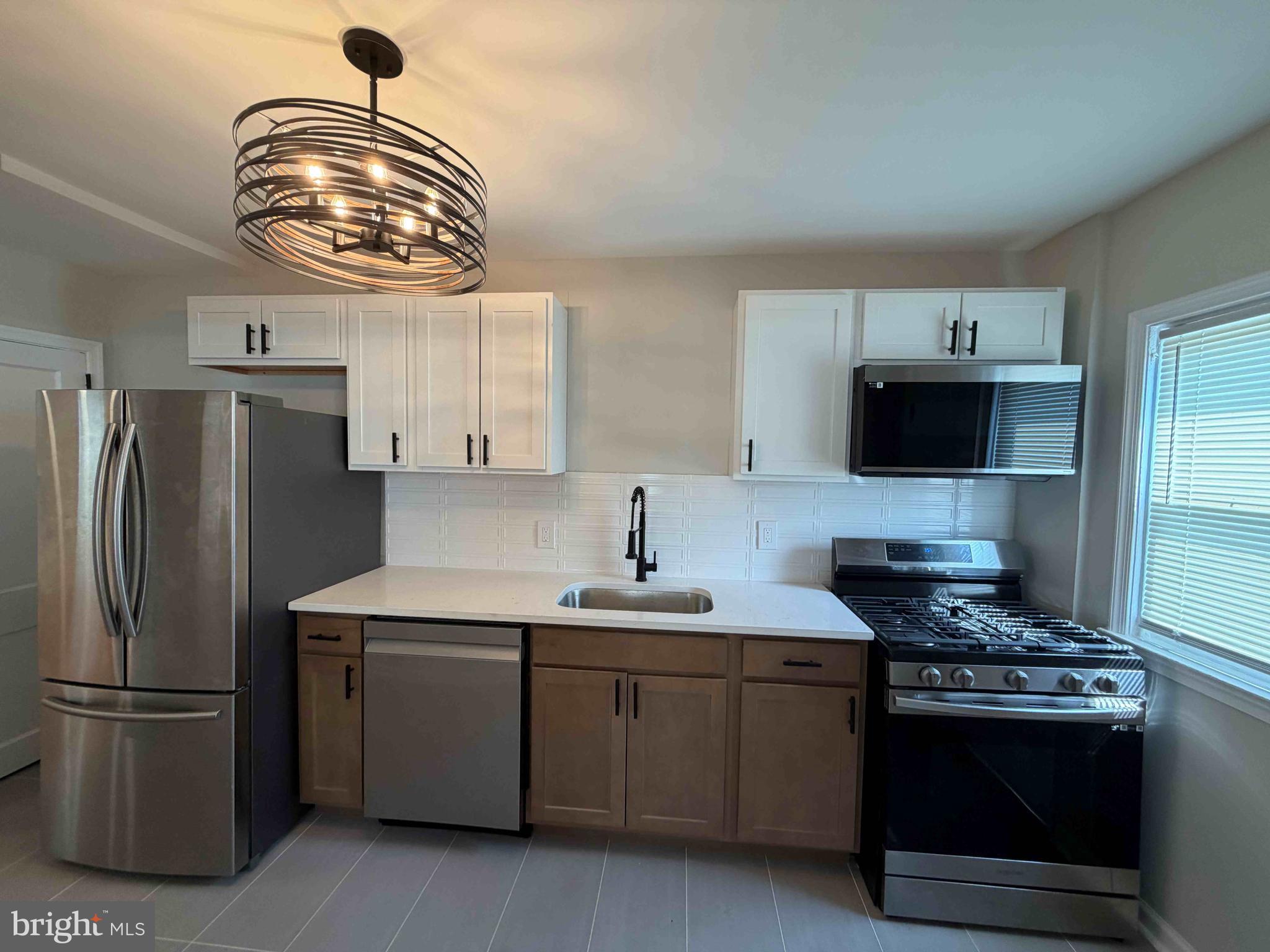 1535 East Cold Spring Lane Baltimore, MD 21218 - Photo 8 of 24 a kitchen with stainless steel appliances a stove a sink and a refrigerator