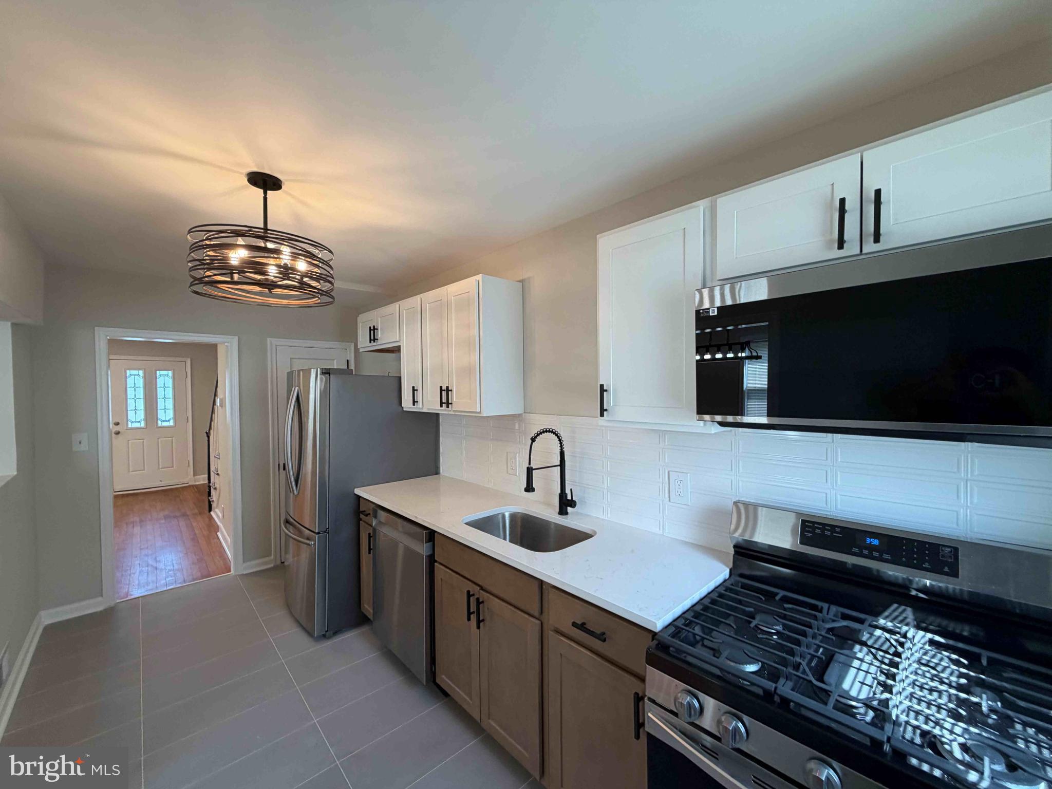 1535 East Cold Spring Lane Baltimore, MD 21218 - Photo 10 of 24 a kitchen with stainless steel appliances a sink stove and microwave