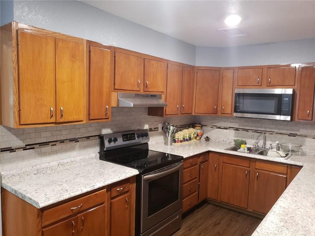 18901 Hogeye Road, Unit A Manor, TX 78653 - Photo 3 of 10 a kitchen with a sink stove and microwave