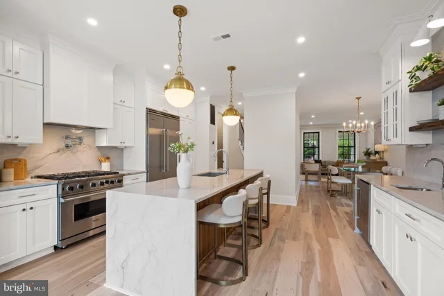 a kitchen with stainless steel appliances granite countertop a stove and a refrigerator