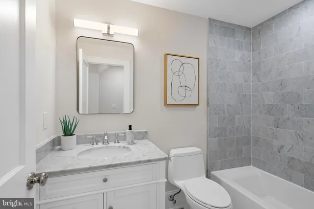 a bedroom with a large bed and a rug