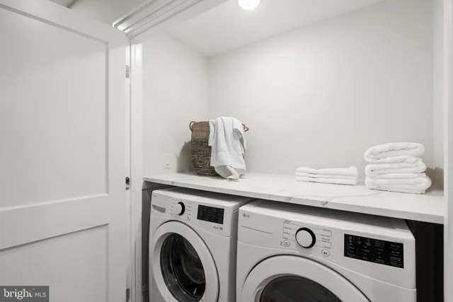 a view of a bedroom with wooden floor and window