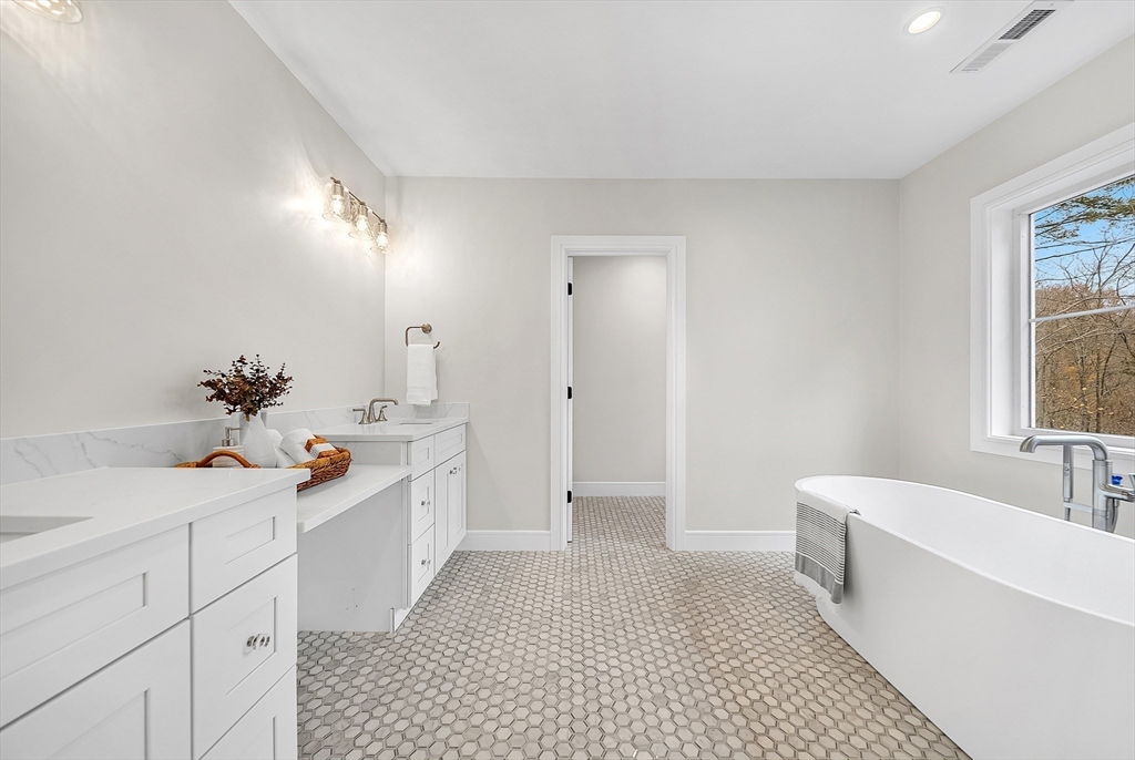 29 Irving Road Natick, MA 01760 - Photo 22 of 42 a spacious bathroom with a double vanity sink a large mirror and a bathtub